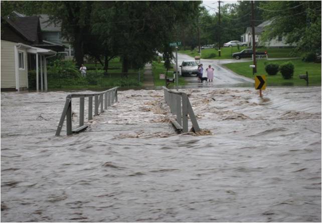 flood water covering bridge and roadway